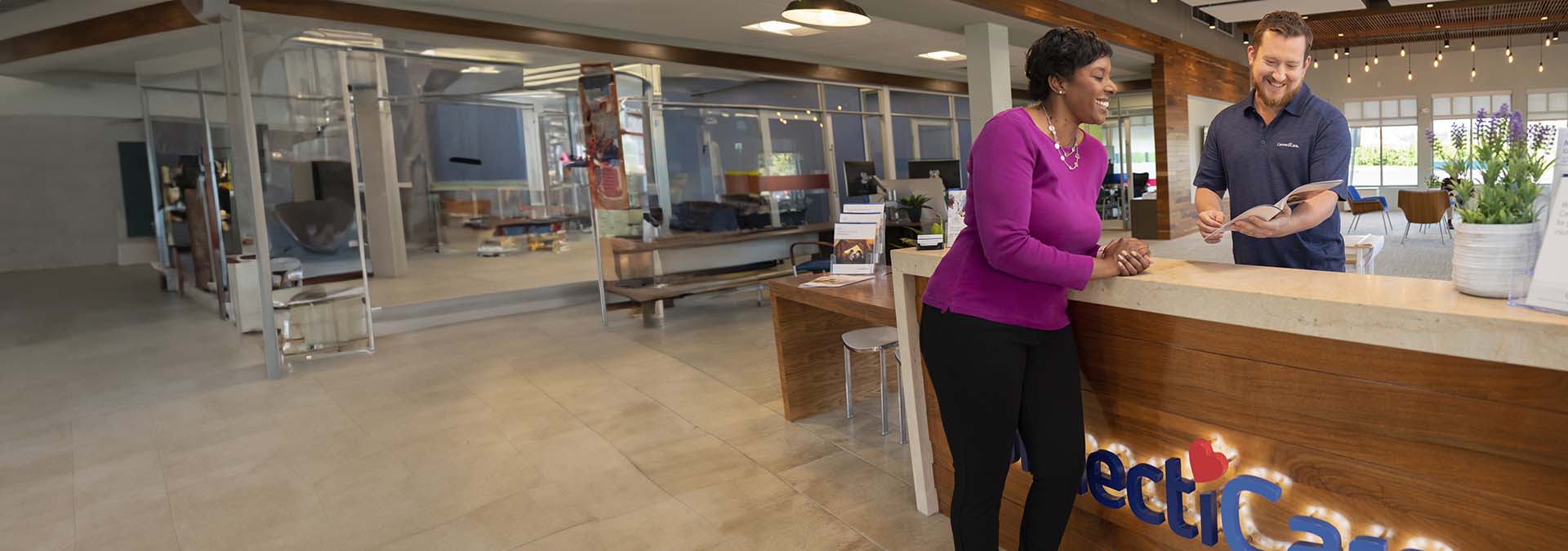 receptionist with customer at a ConnectiCare office