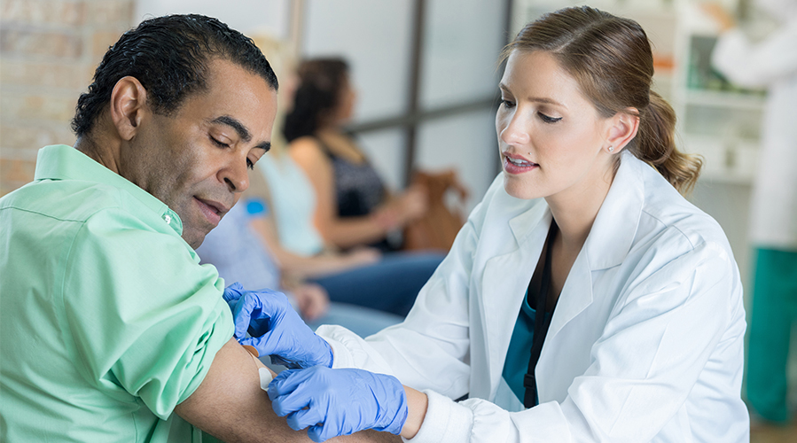 Healthcare professional giving a patient a preventative vaccination.
