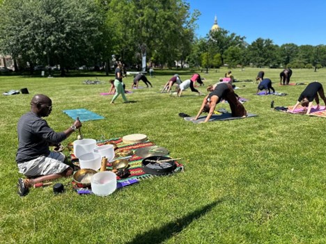 Kelvin Young, certified sound healer, performs a sound bath while participants enjoy a Yoga In Our City class in Hartford’s Bushnell Park.