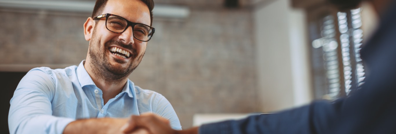 Man laughing with colleague