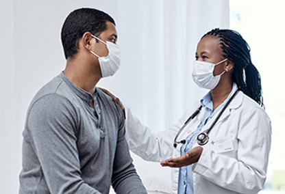 Doctor and patient talking wearing masks