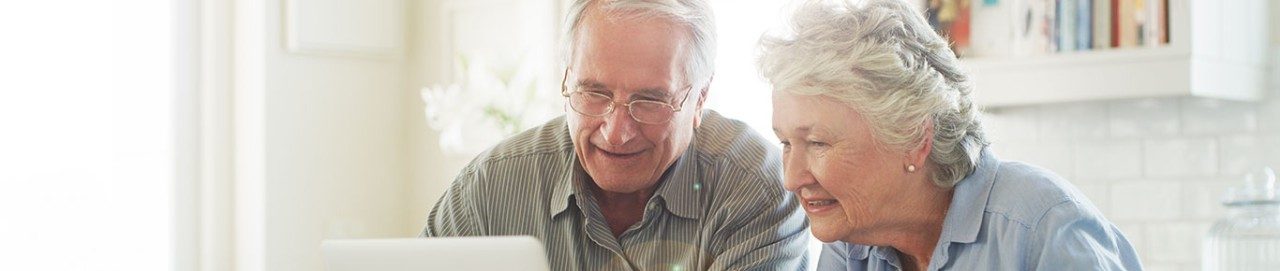Shot of senior couple using a laptop together at home