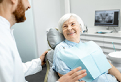 Older woman in dentist patient chair smiling