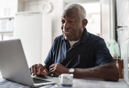 Man on laptop looking for Medicare pharmacy and drug prices