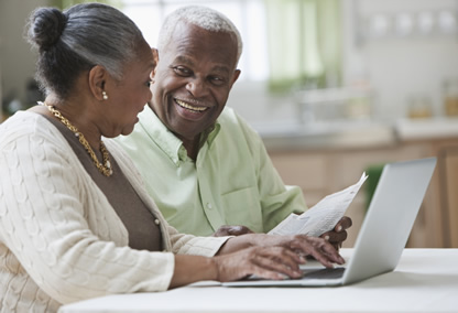 Husband and wife on the computer and reading document