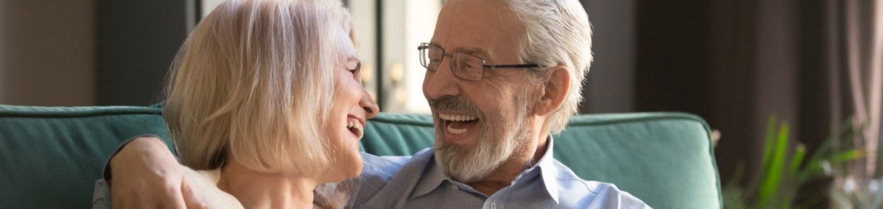 Man and woman laughing and looking at each other