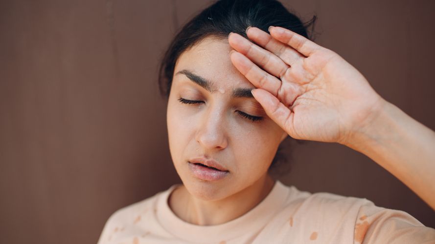 young-woman-wipes-sweat-from-brow 