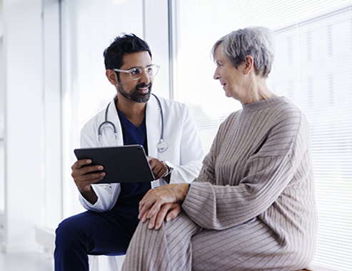 Young female doctor with older patient